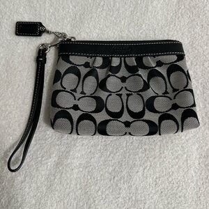 Coach wristlet black leather with gray background